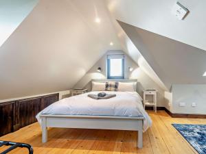 a bedroom with a white bed in a attic at 1 Bed in Isle Of Arran oc-ca272 in Pirnmill
