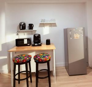 a kitchen with a counter with two stools and a refrigerator at Private Spacious Walkout Suite Near Downtown in Halifax