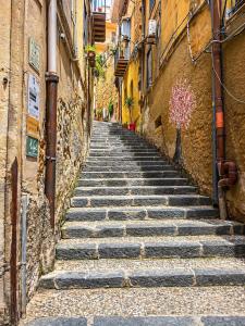 an alley with stone stairs in an old town at Atenè Rooms in Agrigento