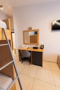 a room with a desk and a bunk bed at Cynthia in Nea Vrasna