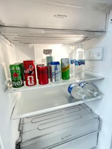 an open refrigerator filled with drinks and soda at Casa Alto Padrão 3 Quartos - Perto do Shopping Sinop in Sinop