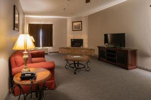 a living room with a couch and a tv at Branson Towers Hotel in Branson