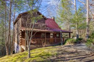 a log cabin with a deck in the woods at Mountain Memories Is A Perfect Mountain Getaway For A Family Or Couples Retreat! in Sevierville