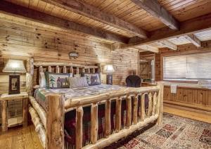 a bedroom with a bed in a log cabin at Mountain Memories Is A Perfect Mountain Getaway For A Family Or Couples Retreat! in Sevierville