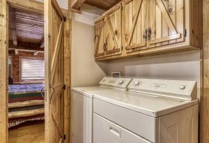 a laundry room with a washer and dryer at Mountain Memories Is A Perfect Mountain Getaway For A Family Or Couples Retreat! in Sevierville +26 photos