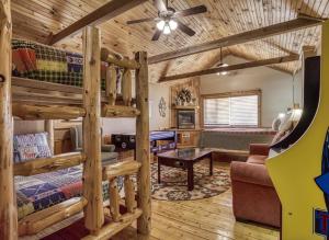 a log cabin bedroom with a bunk bed and a couch at Mountain Memories Is A Perfect Mountain Getaway For A Family Or Couples Retreat! in Sevierville