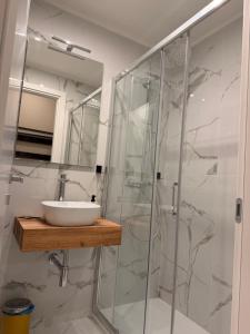 a bathroom with a sink and a glass shower at Velvet Rooms Florence in Florence +49 photos