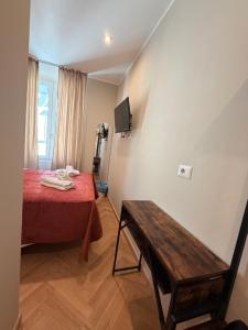 a small room with a bed and a table at Velvet Rooms Florence in Florence