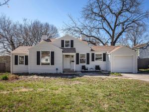 a white house with a lawn in front of it at Charming 3BD 2BR Dog Friendly in Overland Park