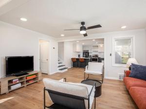 a living room with a couch and a flat screen tv at Charming 3BD 2BR Dog Friendly in Overland Park