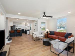 a living room with a couch and a table at Charming 3BD 2BR Dog Friendly in Overland Park