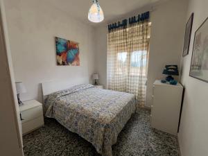 a small bedroom with a bed and a window at La casa del professore libeccio in Nicotera Marina