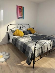 a bedroom with a bed with a black frame and yellow pillows at Private Spacious Walkout Suite Near Downtown in Halifax