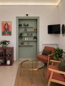 a living room with a couch and a table at Atenè Rooms in Agrigento