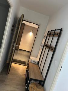 a hallway with a mirror and a stair case at Patty Home Stay in Carrières-sous-Poissy +5 photos