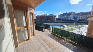 a balcony with a view of a swimming pool at Enoturismo-Noja in Noja
