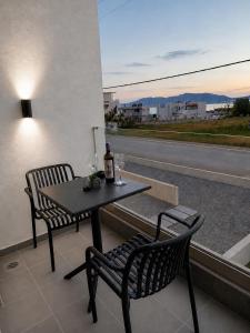 a table and two chairs sitting on a balcony with a view at Haraki Emerald in Haraki