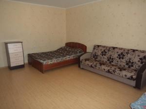 a bedroom with two beds and a dresser in it at Apartment on Komsomolskaya 8 in Kirov