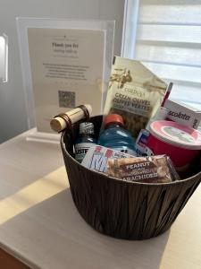 a basket of food and medicines on a table at Private Spacious Walkout Suite Near Downtown in Halifax +21 photos
