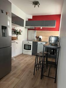 a kitchen with a table and chairs in a room at Maison de ville in Évron