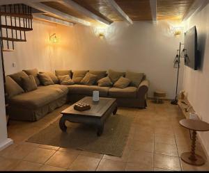 a living room with a couch and a coffee table at Villa la serella in Brando