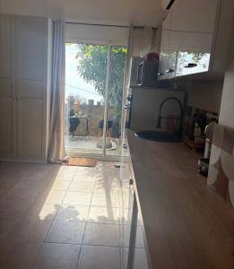 a kitchen with a sliding glass door to a patio at Villa la serella in Brando +7 photos