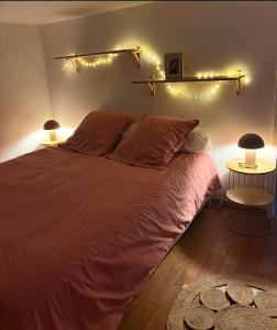 a bedroom with a bed with lights on the wall at Villa la serella in Brando