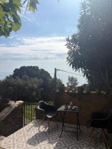 a patio with two chairs and a table with a view at Villa la serella in Brando