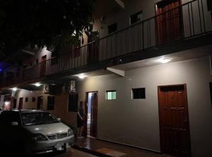 a car parked in front of a building at night at Marina Hotel in Ciudad del Este +5 photos