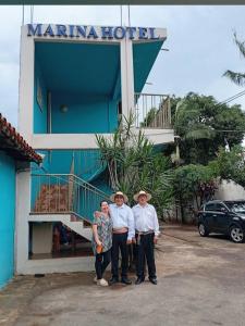 a group of three people standing in front of a hotel at Marina Hotel in Ciudad del Este