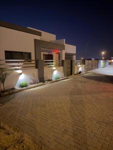 a large house with a driveway in front of it at night at Oregano Estate in Swakopmund