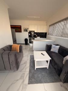 a living room with two couches and a coffee table at Oregano Estate in Swakopmund