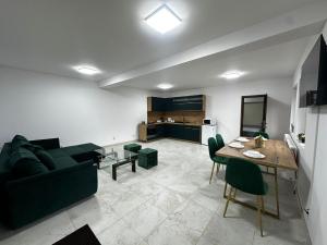 a living room with a black couch and a table at Robert Urban Class in Gura Humorului