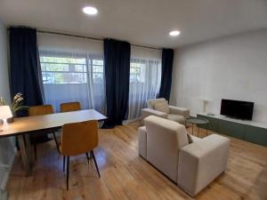a living room with a table and chairs and a couch at Pokoje w Centrum - Parking - Rowery in Sopot