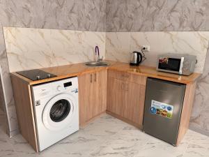 a kitchen with a washing machine and a sink at Готель-ГАЙСИН-Ресторан in Haysyn