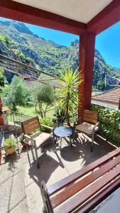a patio with two benches and a table with a view at Red House Apartment in Kotor