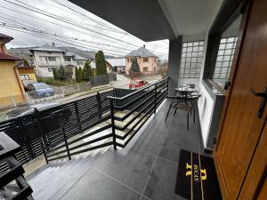 a room with a balcony with a view of a street at Robert Urban Class in Gura Humorului