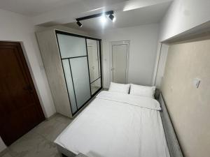 a large white bed in a room with a large window at Robert Urban Class in Gura Humorului