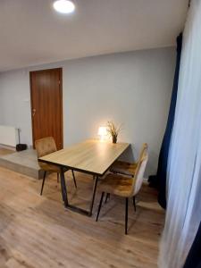 a dining room table and chairs in a room at Pokoje w Centrum - Parking - Rowery in Sopot +30 photos