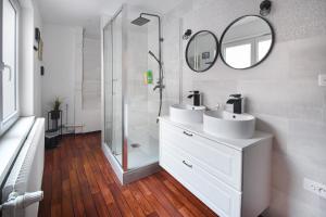 a bathroom with two sinks and a shower at Au Bretzel Doré - Centre Historique in Colmar +17 photos