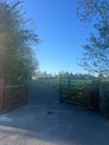 a gate on a road with a fence at The Cuckoos Nest - 2 bedroom in Headford