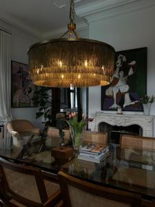 a dining room with a glass table and a chandelier at Villa Pomona in Bled