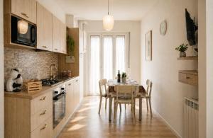a kitchen with a table and a dining room at Home Istria 81 in Trieste