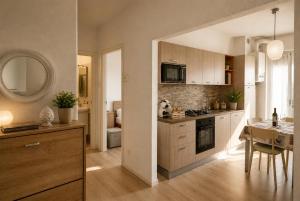 a kitchen with a table and a dining room at Home Istria 81 in Trieste +5 photos