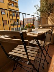 a wooden table and chairs on a balcony at Home Istria 81 in Trieste