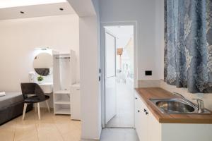 a small kitchen with a sink and a shower at Villa Bella in Ksamil