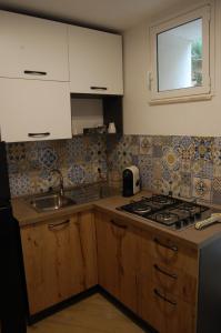 a kitchen with a sink and a stove top oven at La Dimora Sicula in Modica