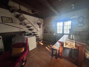 a kitchen with a wooden table in a room at Le Cabanon in Mane