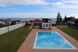 a swimming pool in the yard of a house at CASA SIMBA , where the fun begins in Ponta Delgada