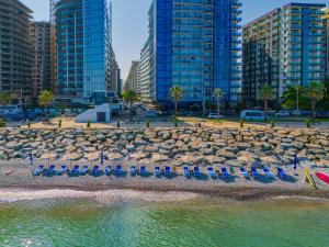 a group of chairs and umbrellas on a beach at Wyn Residence Batumi in Batumi
